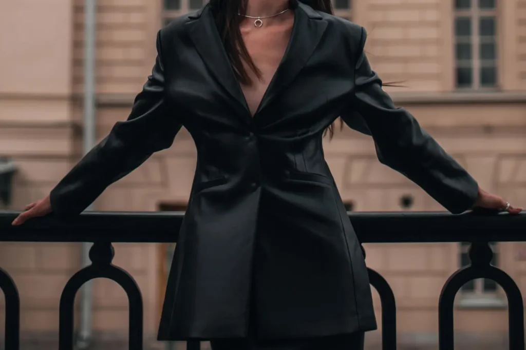 Mulher usando um blazer elegante preto, peça essencial da alfaiataria feminina.
