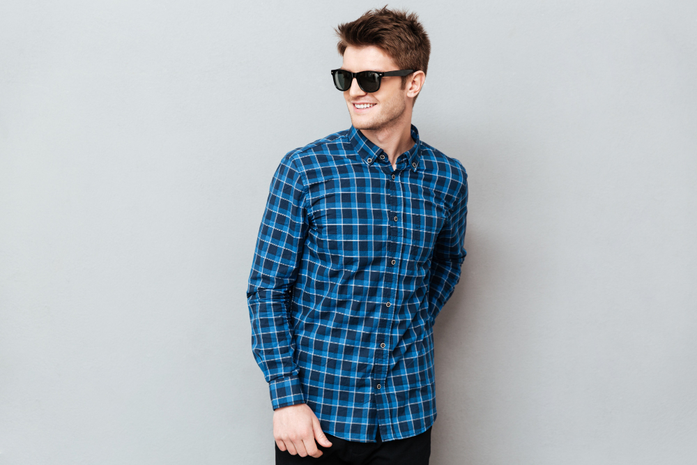 Types of shirts: A man wearing a blue plaid shirt and sunglasses.