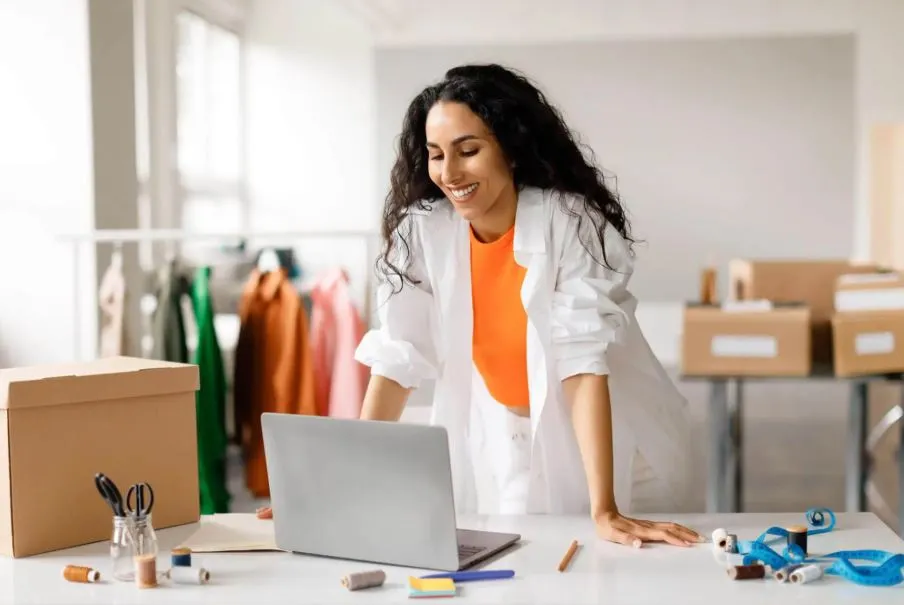 Fashion technology: a fashion professional working on a laptop.