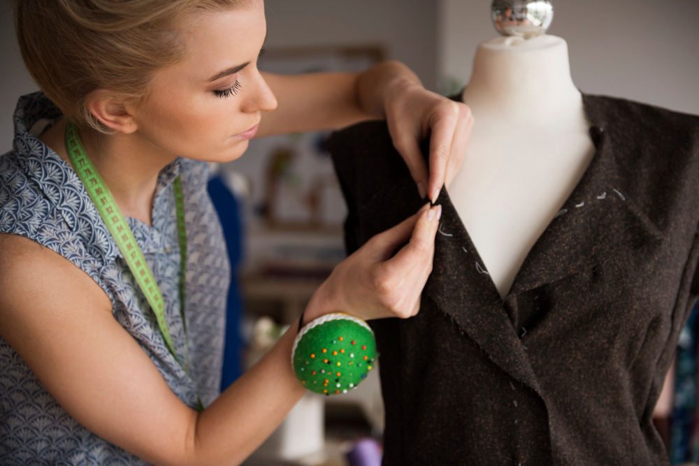 Haute couture: a woman draping on a mannequin.