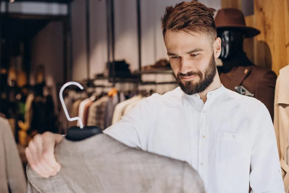Types of shirts: A man in a white shirt choosing a blazer.