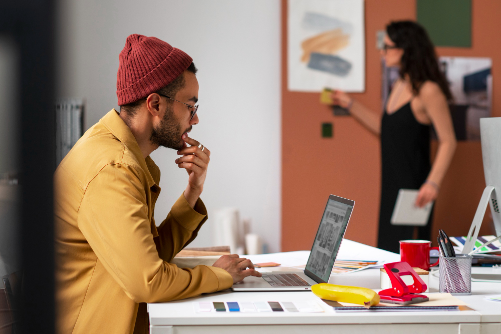 Fashion AI: A fashion designer working on a computer in an office.