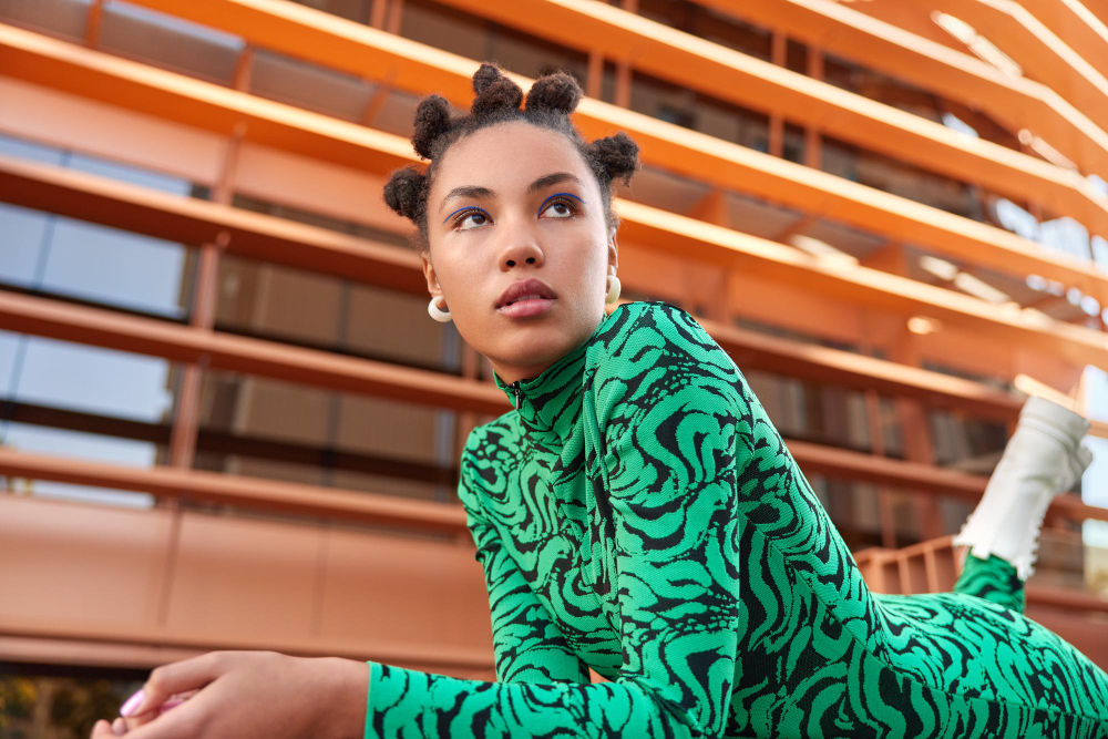 Fashion trends: a woman wearing stylish clothes in shades of green.