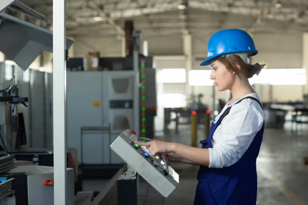 Muebles en CAD: mujer con un casco azul manejando la pantalla de una máquina industrial