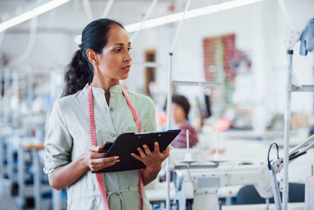 Types of automation: a sewing manager using technology to ensure quality.
