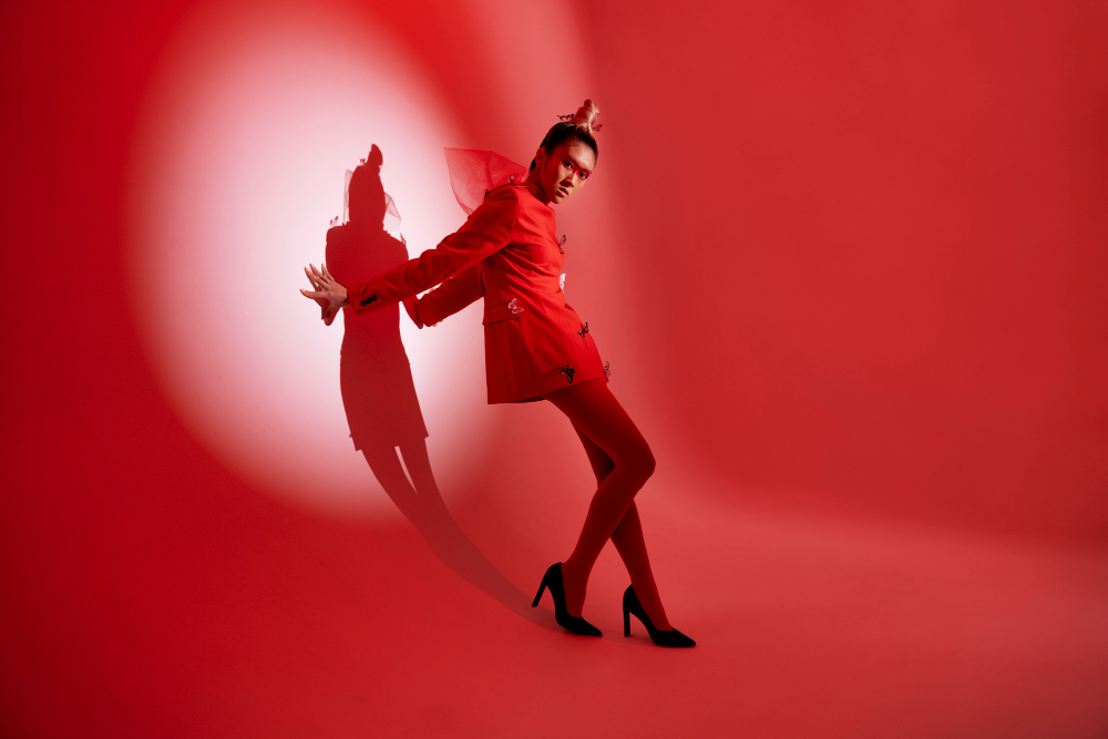 China fashion: an Asian model posing against a red background.