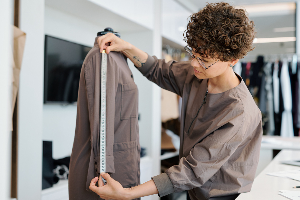 Textile quality control: a professional measuring a garment on a mannequin.