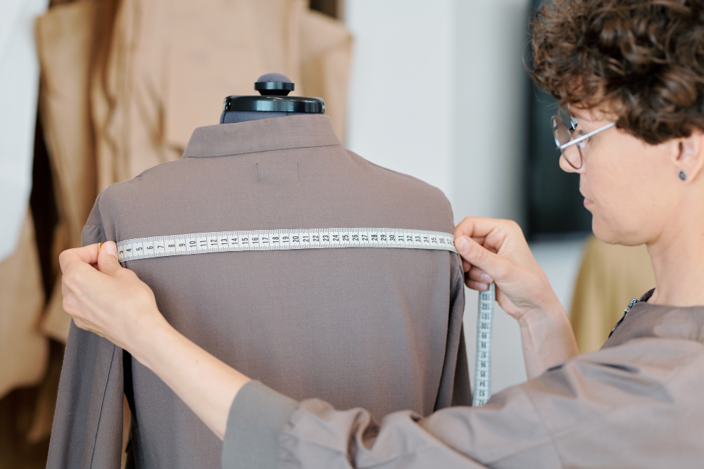 Textile quality control: a fashion professional inspecting a garment.
