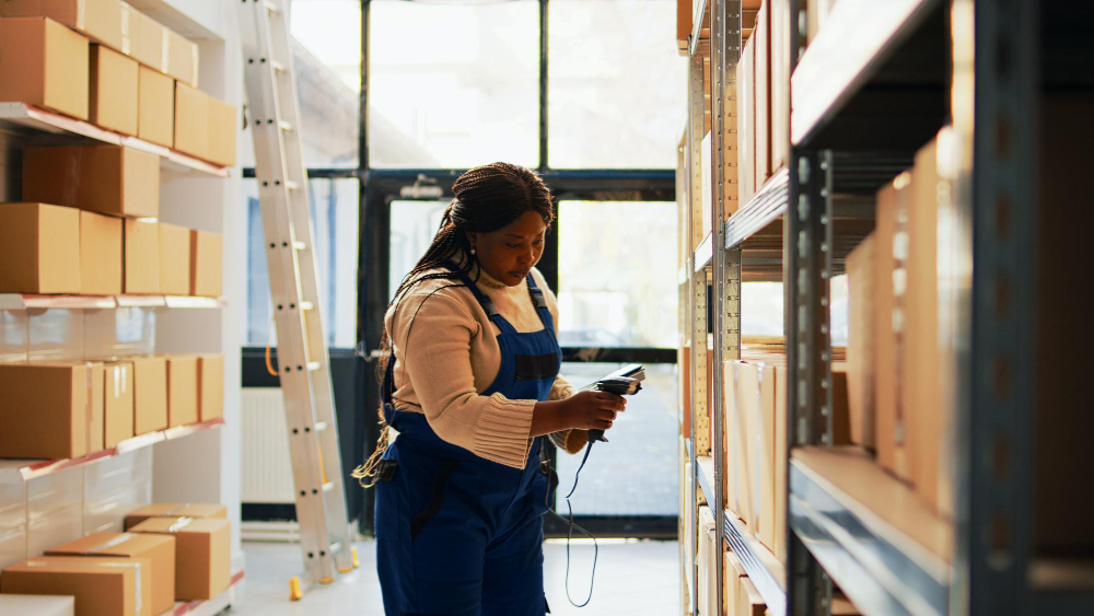 Production terms: a logistics professional scanning boxes.