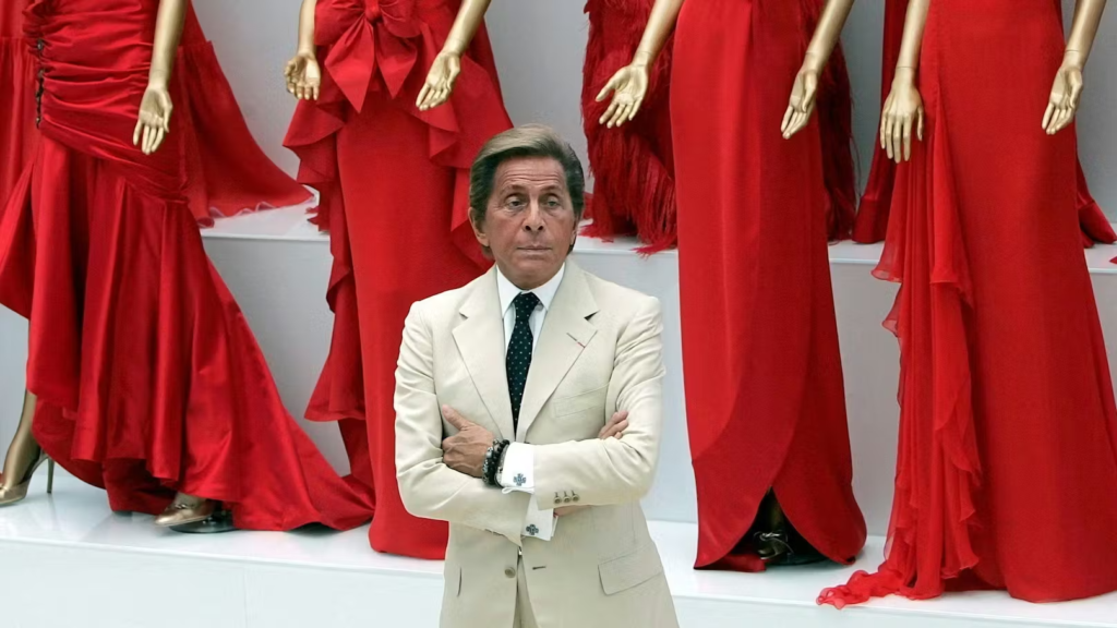 Valentino Garavani: the iconic Italian designer seated in front of his creations. Photo: Reuters/Alessandro Bianchi