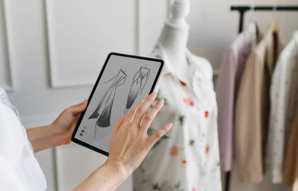 Digitalizaci&oacute;n de procesos: persona mirando un dibujo de moda virtual en un taller