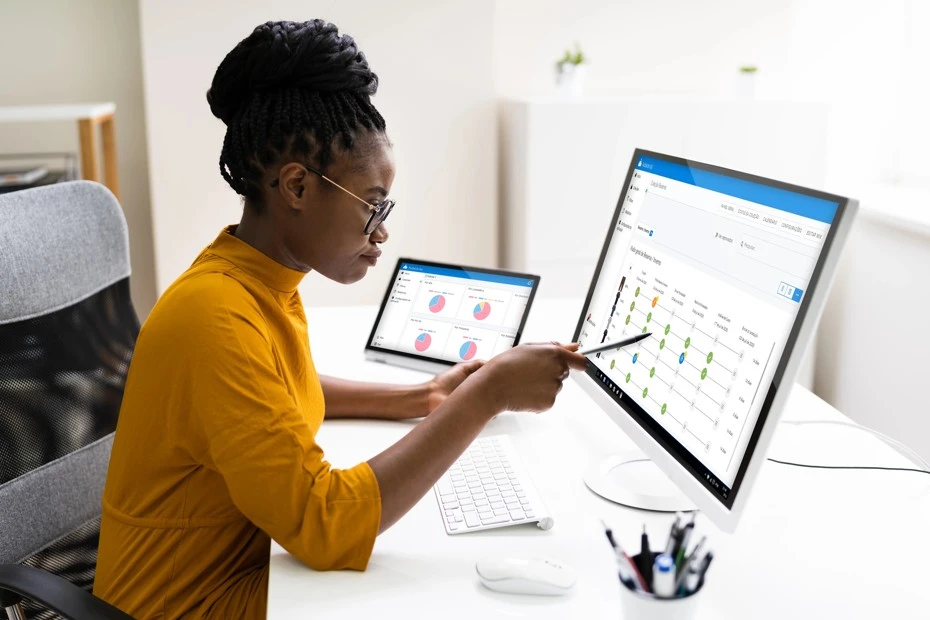 A fashion industry professional monitoring product performance indicators using PLM technology.